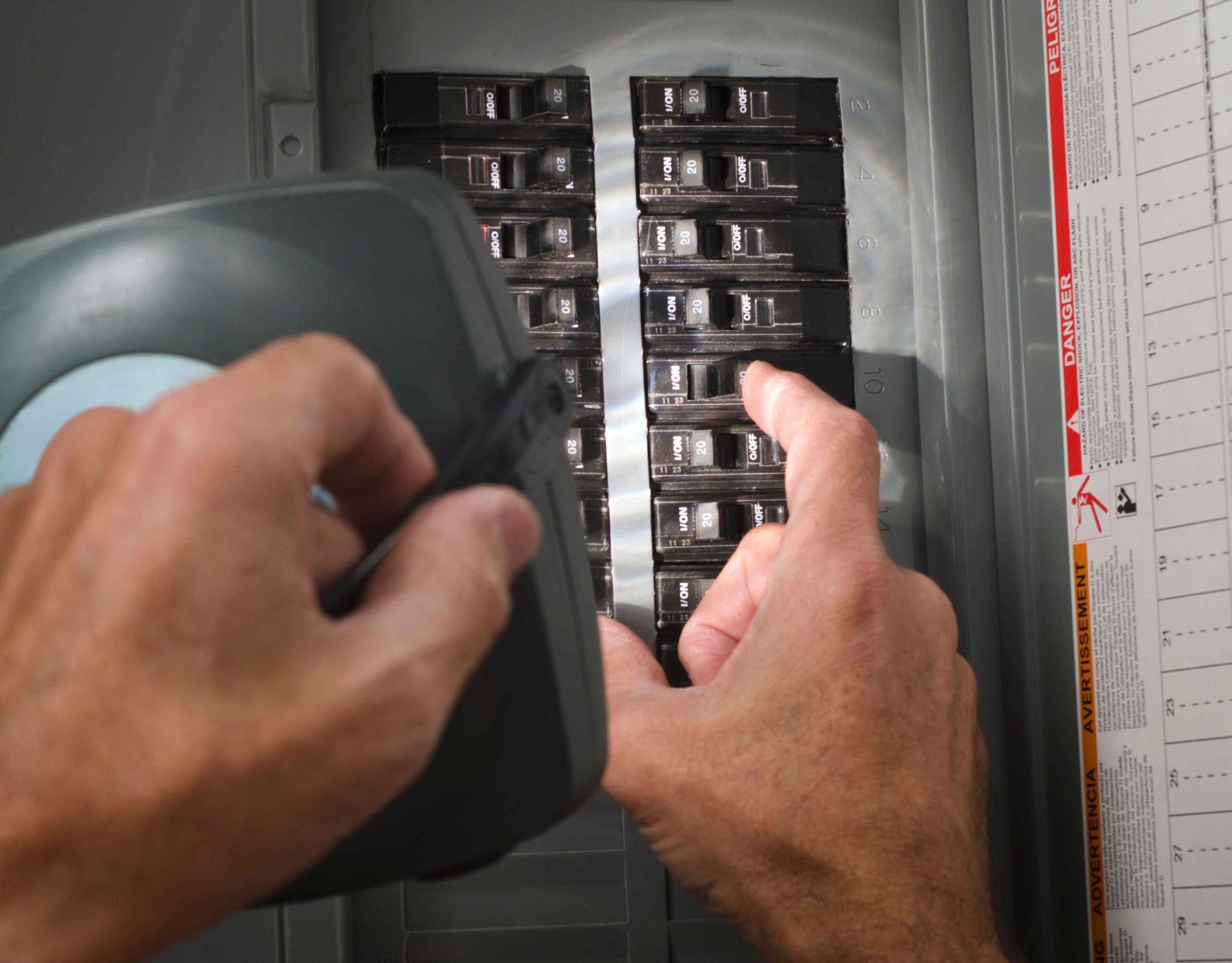 Electrician checking an electrical panel